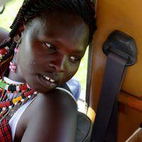 Maasai guide in safari jeep on Basecamp Explorer game drive in Masai Mara.