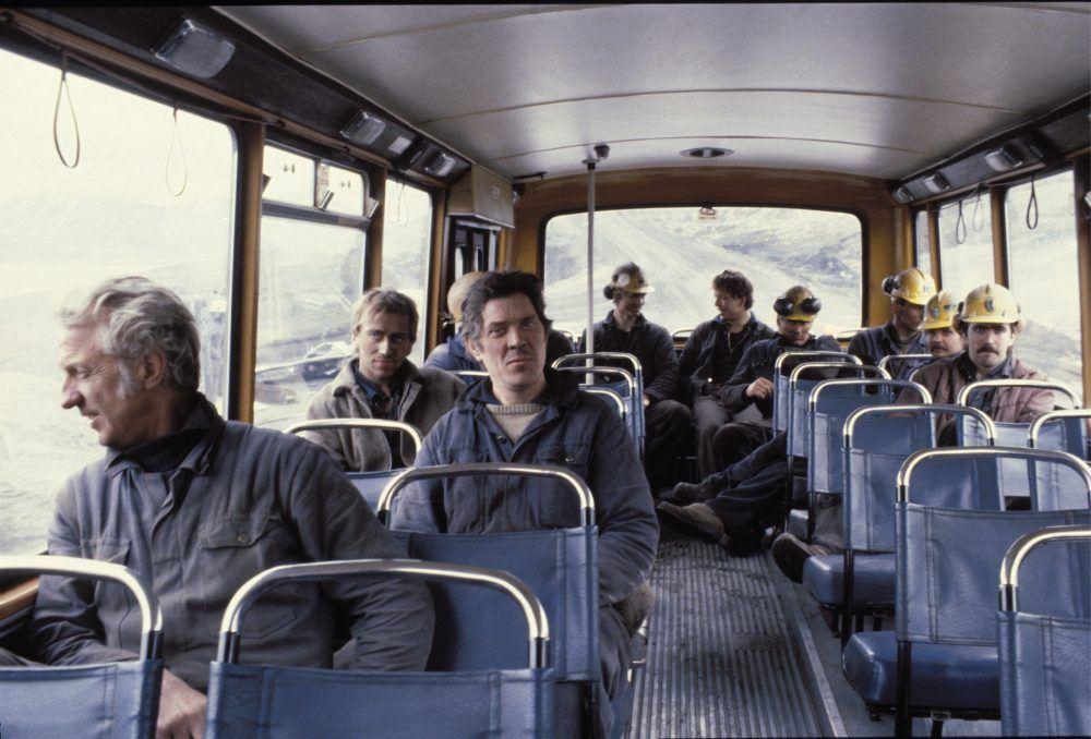 Old photo of coal miners on bus in Spitsbergen.