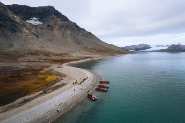 People, boats and Svalbard mountains